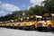 Shot of yellow School buses parked in parallel in a yard parking for service repair during daytime