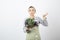 Shot of young cook holding plate of cabbage and broccoli on white background