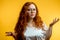 shot of young funny redhead female stares at camera with shoked expression