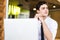 Shot of young man sitting at table looking away and thinking. Thoughtful businessman sitting home office. Sales man