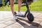Shot of a young person legs and calves as they stand on the electric kick scooter