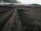 Shotof the black sandy road in the desert of Fuerteventura, Spain.