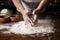 shots of hands kneading dough in a bakery, flour dusted on wooden table