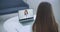 Shoulder view young woman consulting with family therapist doctor general practitioner online via video call on laptop
