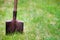 Shovel in green grass