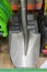 Shovels in a hardware store. Garden shop with wooden spades for sale. vertical photo