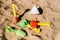 Shovels and rakes to play on the beach in summer on the sand, abandoned