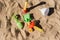 Shovels and rakes to play on the beach in summer on the sand, abandoned