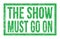 THE SHOW MUST GO ON, words on green rectangle stamp sign