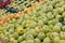 Showcase with apples in a supermarket. A lot of green apples. The choice of products. Fruit