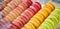 Showcase of rows of french macaroons. Close up of macaroon cookies