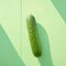showcased on tranquil pastel green surface, minimalist style Single cucumber