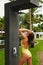 Shower On Beach. Woman In Swimsuit Showering At Pool Shower.