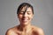 The shower has the ability to make you completely happy. Studio shot of a young woman enjoying a shower against a gray