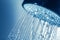 Shower Head with Water Stream on Blue Background