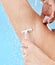 Shower, underarm and woman shaving body or armpit in studio on a blue background for grooming with water drops. Cleaning