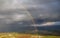 Showers and rainbow over the Sea of Galilee, Israel`s natural water sources, on a winter day with dramatic rain clouds scenery