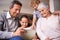 Showing granny and gramps the latest tech. A shot of two kids and their grandparents using a digital tablet while