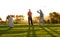 Showing him how its done. Two male golfers playing a round of golf.