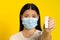 Showing positive test scared of pandemic mature asian woman wearing medical face mask coronavirus or monkeypox