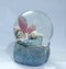 Showpiece of angel with wings sleeping on flower inside a glass dome