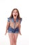 Shows different emotions, Portrait of a beautiful female model wearing denim shorts and brown shirt on white background. scream,