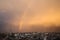 Shows a rainbow in the sky above Rafah on a rainy day at sunset in the southern Gaza Strip