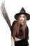 Showy young woman in witch costume with a broom