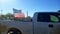 Shredded American Flag Flying on Back of Pickup Truck