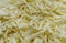 Shredded cheese background.Heap of Grated pizza cheese close up texture