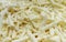 Shredded cheese background.Heap of Grated pizza cheese close up texture