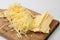 Shredded cheese on wooden kitchen board