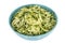 Shredded Grated Raw Zucchini or Courgette Served in Blue Bowl with White Spots