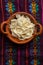 Shredded Oaxaca cheese also called quesillo on rustic background. Mexican food