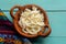 Shredded Oaxaca cheese also called quesillo on turquoise background. Mexican food