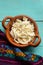 Shredded Oaxaca cheese also called quesillo on turquoise background. Mexican food