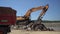 Shredding dredging. The dump truck leaves after unloading.