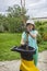 Shredding garden waste. Girl works with a garden shredder