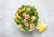 Shrimp arugula salad with avocado slices, high angle view of ready-to-eat dish
