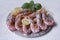 Shrimp baking with lemon slices on a white background