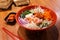 Shrimp Bibimbap Noodles, Korean noodles mixed with radish, sprout, carrot, cabbage, cucumber,  boil egg and Gochujang in red bowl.