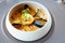 Shrimp Bisque with Seafood. King prawn, blue mussels, cod, whipped cream. Delicious traditional food closeup served for