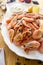 Shrimp boiled with lemon sauce on a wooden table side view close-up