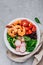 Shrimp Burrito Bowl with brown rice, spinach, radish, black beans, tomato and broccoli.