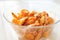 Shrimp food in a bowl. Portion of boiled shrimp in a transparent plate on the table.