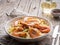 Shrimp, pasta tagliatelle, green peas, dill. White plate on old rustic wooden table, side view, copy space