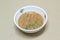 Shrimp paste sauce in plastic bowl on cardboard background