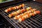 shrimp skewers cooking over grill grates