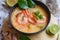 Shrimp soup bowl, seafood soup with shrimps prawns in the restaurant, Traditional thai cuisine hot spicy soup shrimp curry with