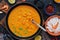 Shrimps with curry sauce in a frying pan on a dark background. . Thai , Indian dish. Asian food.